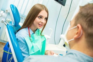 Young woman speaking with  dentist